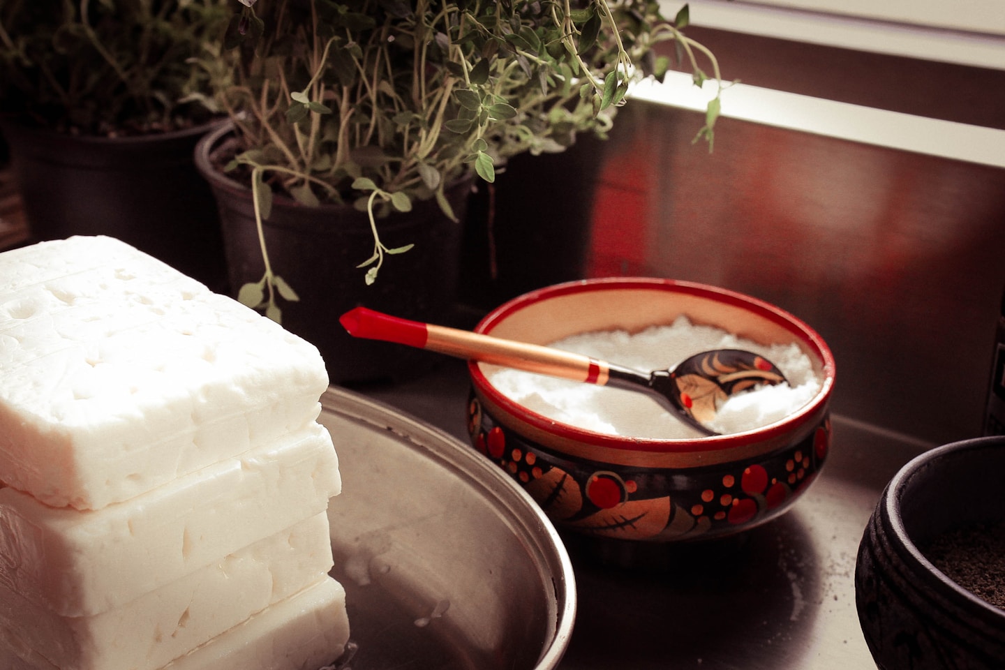 red ceramic bowl on gray spoon