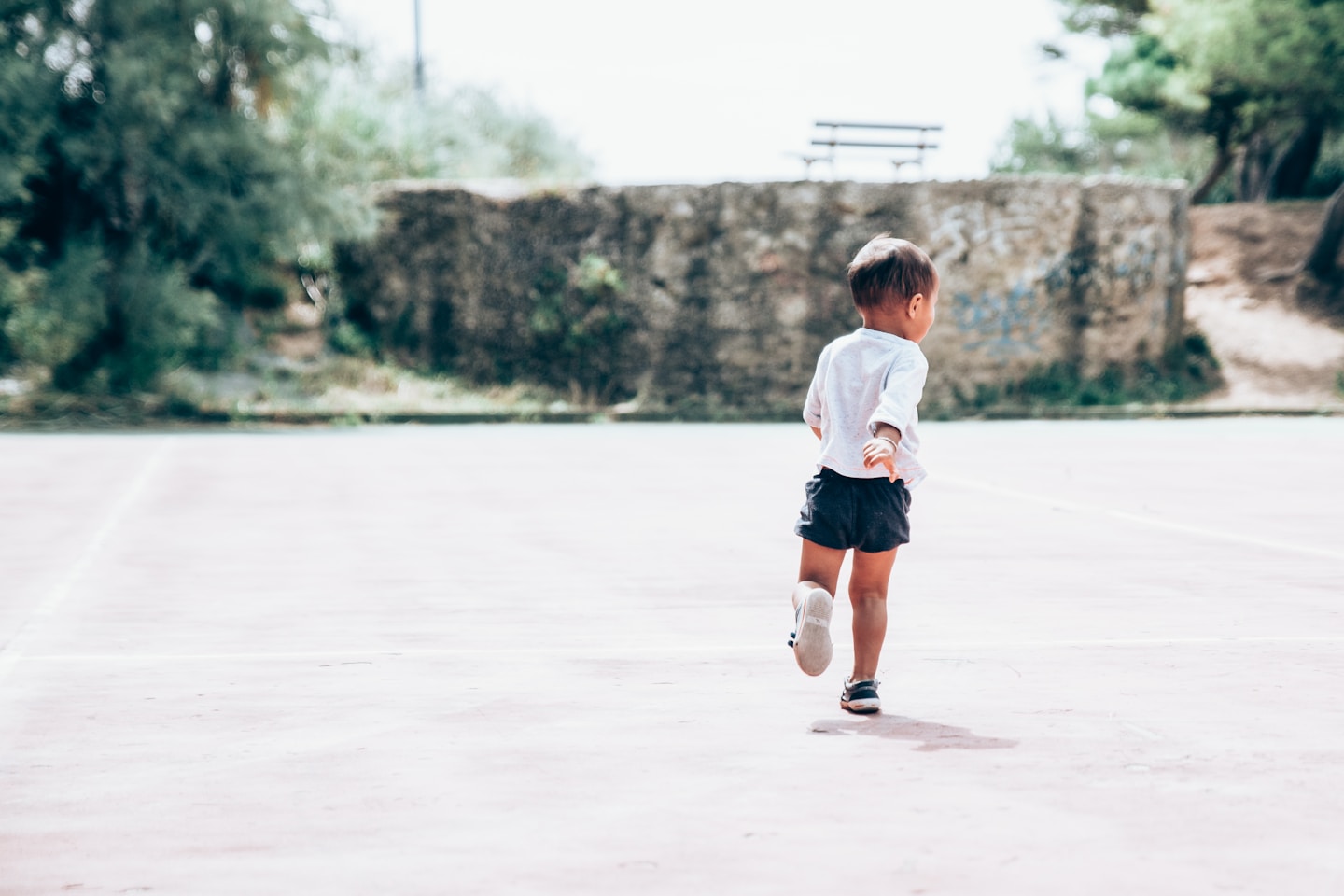 My joyful little boy running on a abandonned tennis court in south of france.