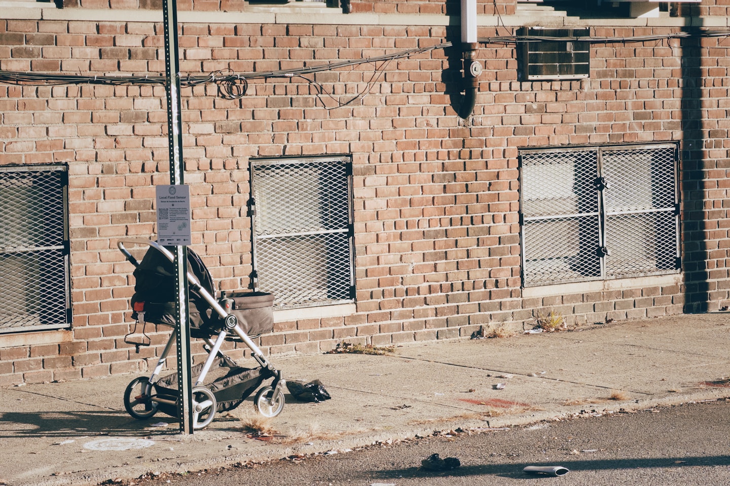 Stroller and debris on a sidewalk.