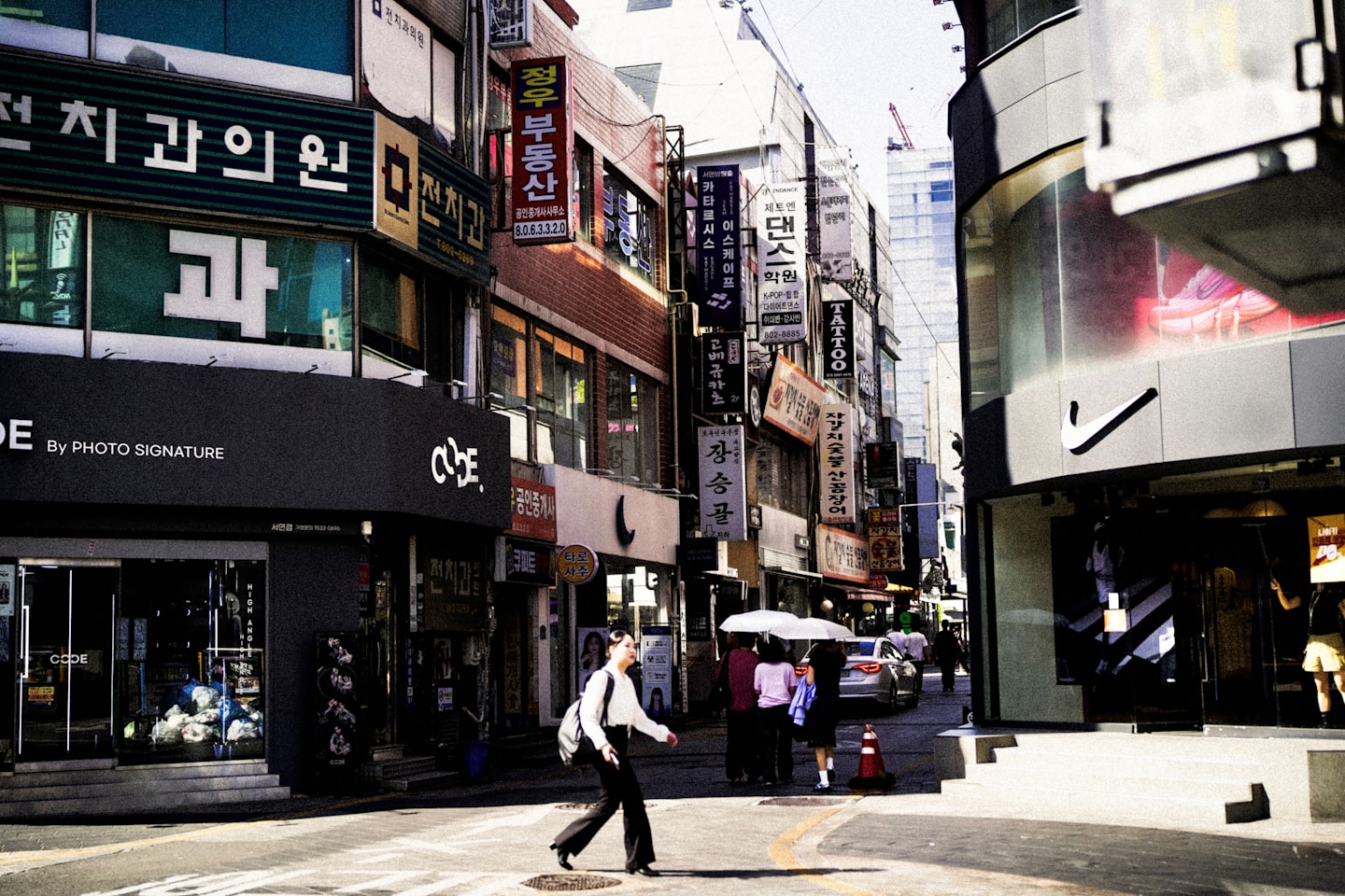A person walks down a busy city street.