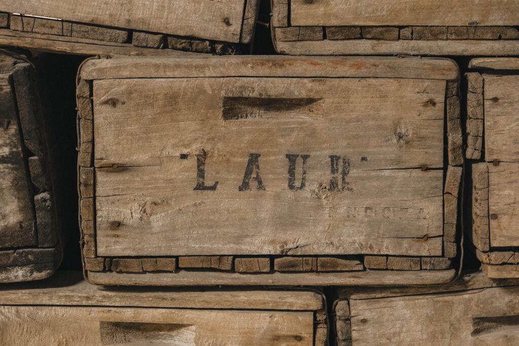 Stack of old wooden crates with "laur" visible
