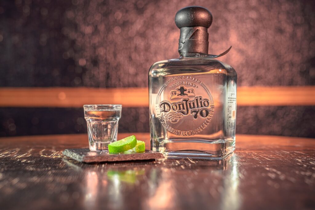 a bottle of tequila tequila next to a shot glass